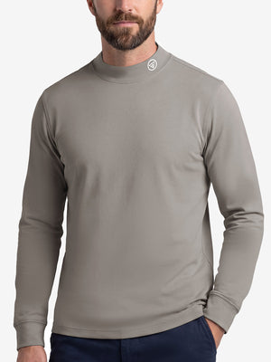 Upper body front view of model wearing sand warm brushed mock neck golf t shirt