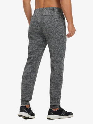 Back lower body view showing black heather soft sweatpants with 4 zipper pockets