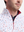 Close-up front view from nose to chest of model wearing white polka dots full print quarter zip sleeveless vest pullover