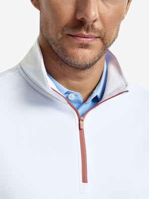 Front shot from nose to chest of model wearing white lightweight sleeveless quarter zip golf vest