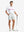 Full-body shot of model holding golf club, styled with Glacier Grey Quick Dry Casual Shorts.
