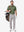 Front full body shot of model wearing green grey ultra-comfort slim fit roma knit polo shirts with golf bag on back
