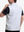 Back upper body shot of model wearing brown grey camo  full print quarter zip sleeveless vest pullover