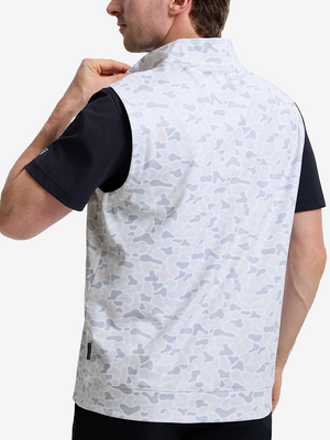 Back upper body shot of model wearing brown grey camo  full print quarter zip sleeveless vest pullover