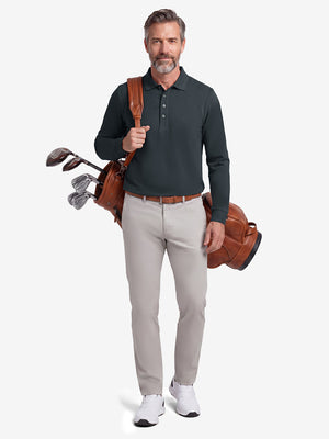 Front full body shot of model wearing dark gray solid stretch cotton pique long sleeve polo shirt while carrying a golf bag on back
