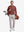 Front full body shot of model wearing wine solid stretch cotton pique long sleeve polo shirt while carrying a golf bag on back