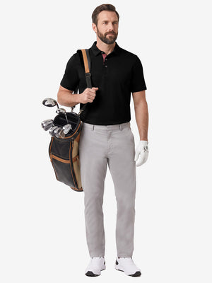 Front full body shot of model wearing black  ultra-comfort slim fit roma knit polo shirts with golf bag on back