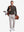 Front full body shot of model wearing dark brown solid stretch cotton pique long sleeve polo shirt while carrying a golf bag on back
