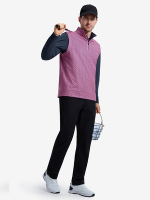Front full body shot of model wearing red navy flower full print quarter zip sleeveless vest pullover with a golf club resting on shoulder in one hand and holding a basket of golf balls in the other hand