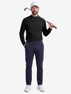 Front full body shot of model wearing black warm brushed mock neck golf t shirt with golf club resting on shoulder