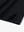 Close-up of hem slit on Everyday Solid Jersey Polo in BLACK, showcasing precise stitching and finish.