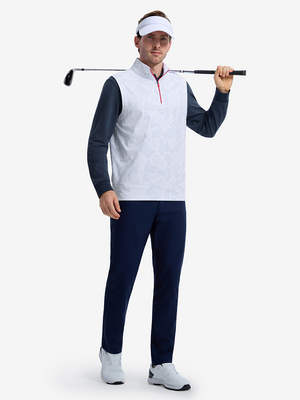 Front full body shot of model wearing grey irregular shape full print quarter zip sleeveless vest pullover with a golf club resting on shoulder