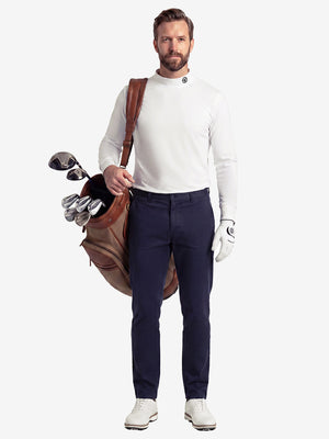 Front full body shot of model wearing beige warm brushed mock neck golf t shirt with golf bag on back