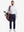 Front full body shot of model wearing white warm brushed mock neck golf t shirt with golf bag on back