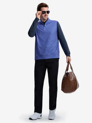 Front full body angled shot of model wearing cobalt wave full print quarter zip sleeveless vest pullover while carrying a bag in one hand