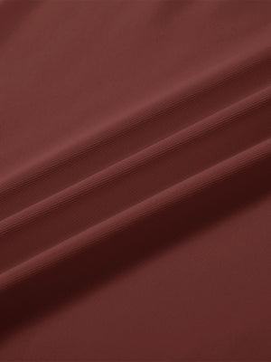 Close-up texture of  wine solid stretch cotton pique long sleeve polo shirts fabric showing detailed premium material and weave