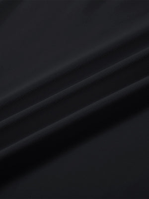 Close-up texture of  black solid stretch cotton pique long sleeve polo shirts fabric showing detailed premium material and weave