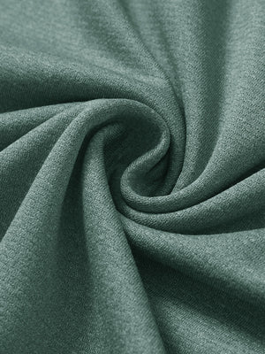 Close-up texture of  dark green melange lightweight sleeveless quarter zip golf vest fabric showing detailed premium material and weave
