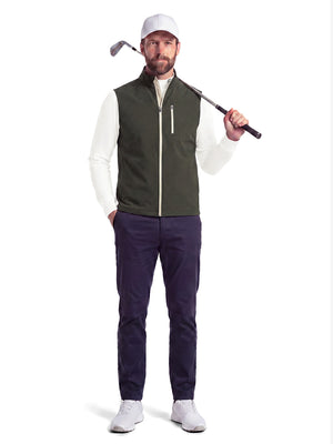 Front full body shot of model wearing beige warm brushed mock neck golf t shirt with golf club resting on shoulder