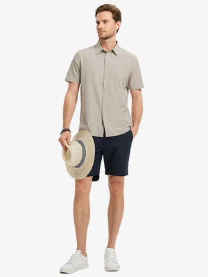 Detail shot with model holding a cap, featuring the DARK KHAKI polo’s side vent.