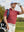 Front upper body angled shot of male model wearing brick red waffle texture 1/4 zip pullover with golf bag and looking into the distance on the golf course